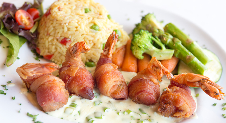 Camarones La Boca (Shrimp stuffed with cheese and red bellpeper wrapped in Bacon)